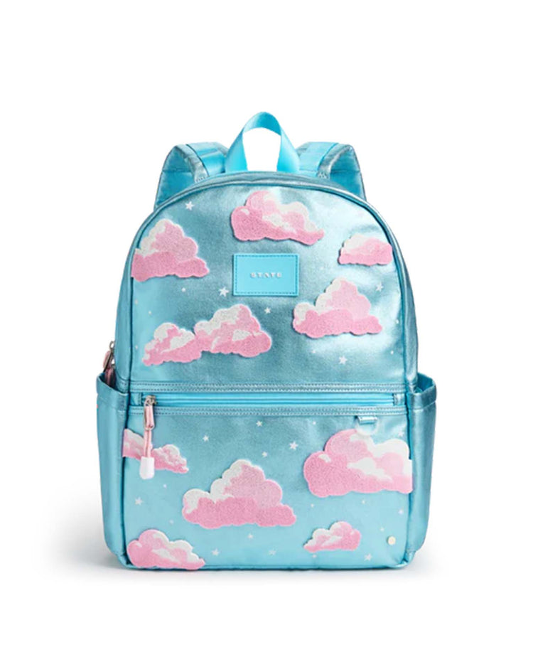 Introducing the Kane Backpack in Clouds by STATE Bags—a sleek, blue school backpack adorned with pink and white fluffy cloud designs and scattered white stars. Inspired by STATE Bags' signature playful aesthetic, it features a convenient front pocket, smooth zipper closure, and sturdy blue straps with a top handle—making it the perfect companion for any adventure.