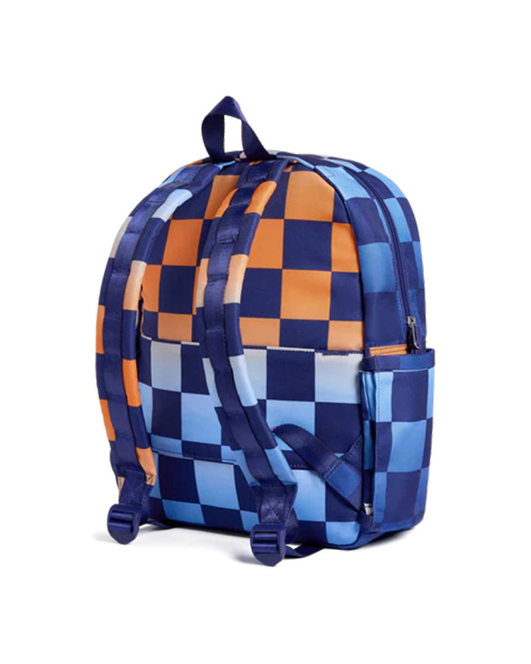 A kane backpack in gradient checkerboard by state bags, featuring two adjustable straps, a top handle, and side pockets, is shown from the back on a white background.
