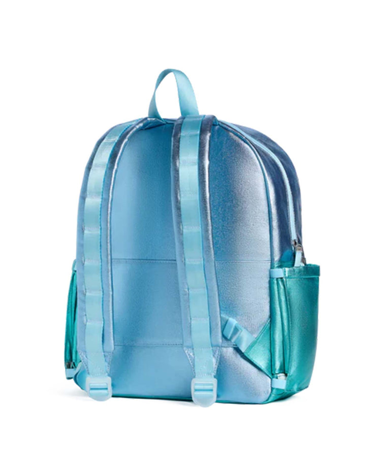 A kane backpack in blue and turquoise colorblock by STATE Bags, featuring adjustable straps, a top handle, and side pockets, is shown from the back against a white background.