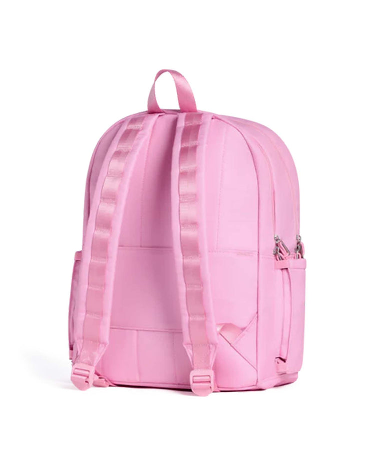The kane double pocket backpack in pink from state bags is displayed from the back, showcasing two adjustable shoulder straps, a top handle, and side pockets against a plain white background—making it ideal as a kids school backpack.