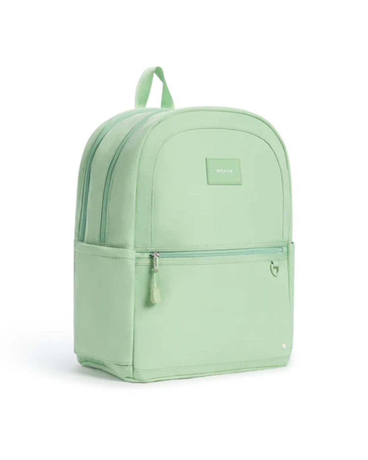 A Kane Double Pocket Backpack in green from State Bags, featuring a front zip pocket, two main compartments, and a top handle—perfect as a stylish school backpack—is displayed on a white background.