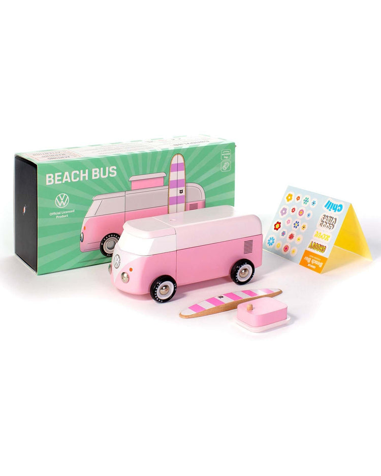 The candylab VW beach bus pink is a modular magnetic toy set with a pink and white wooden surf van, detachable parts, a surfboard, a sticker sheet, and comes in a green "Beach Bus" box featuring an illustration of the van.