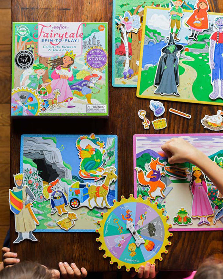 Children ages 5 and up delight in imaginative storytelling with the eeboo fairytale spinner game, a colorful fairy tale-themed spin-to-play board game featuring various story characters and illustrations displayed on a tabletop.