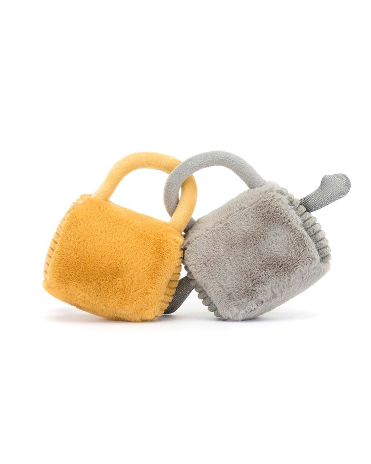 Two plush square toys with handles, one yellow and one gray, are intertwined against a white background—an adorable representation of Jellycat's Amuseable Love Locks for any cute couple to enjoy.