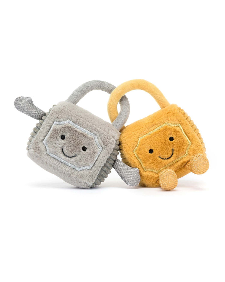 Two plush toys, one gray and one yellow, each with a smiling face and arms, leaning against each other like a cute couple from the Jellycat Amuseable Love Locks collection.