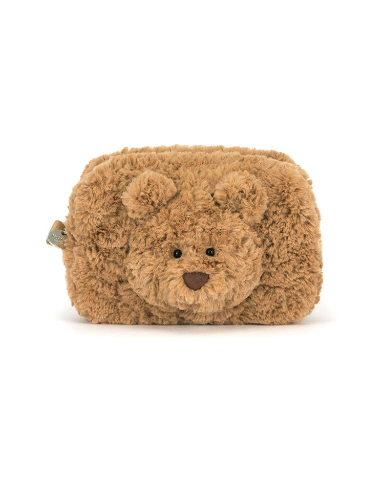 The Jellycat Bartholomew Bear Pouch is a rectangular, fluffy brown pouch with Bartholomew Bear’s face and ears on the front, shown against a white background.