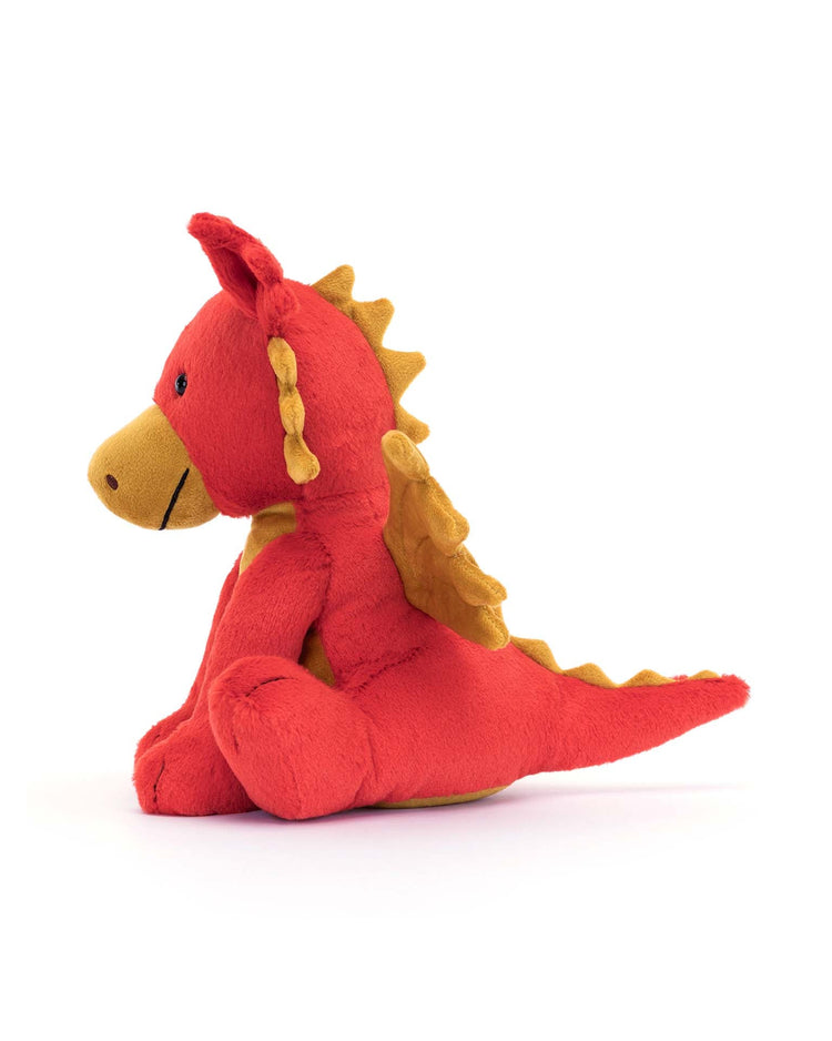 The darvin dragon plush by Jellycat is shown sitting on a white background, facing left.