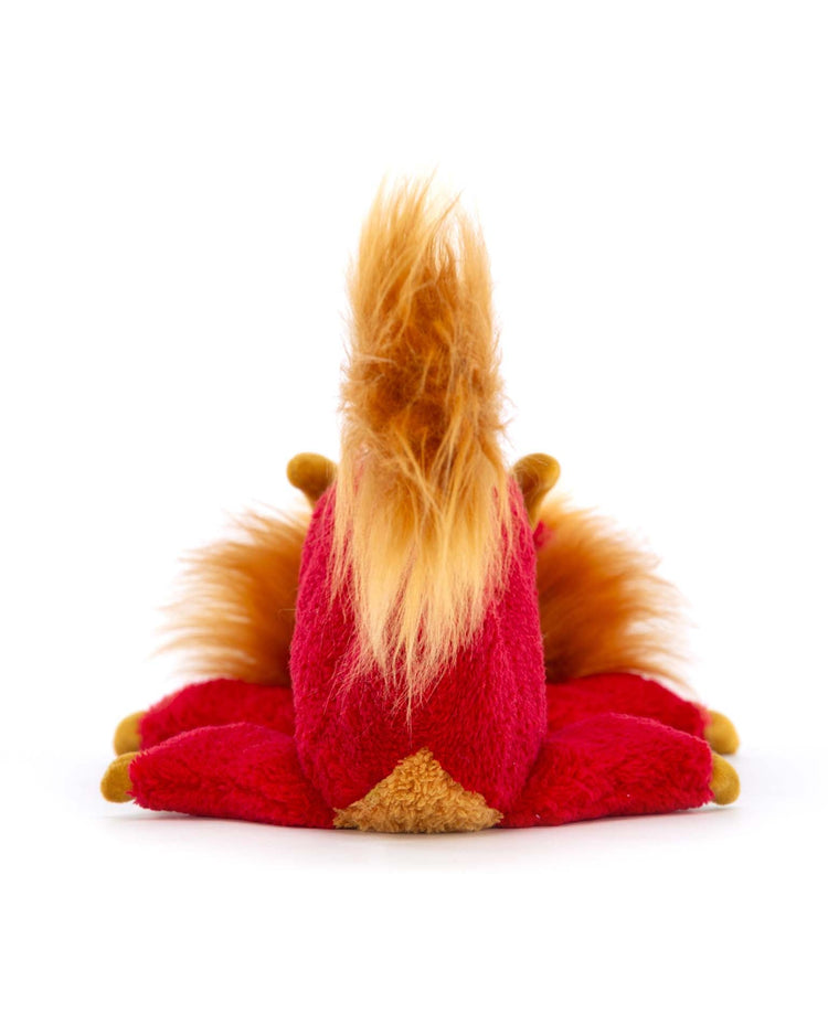 A plush toy named "festival dragon" from the brand Jellycat is seen from the back, displaying a vibrant design and seated legs, isolated on a white background—perfect for any celebration.
