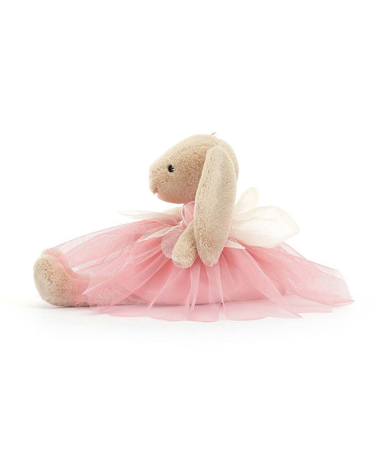A Jellycat Lottie Bunny Fairy, this plush stuffed animal sits upright against a white background, elegantly dressed in a pink ballet costume with a charming white bow.