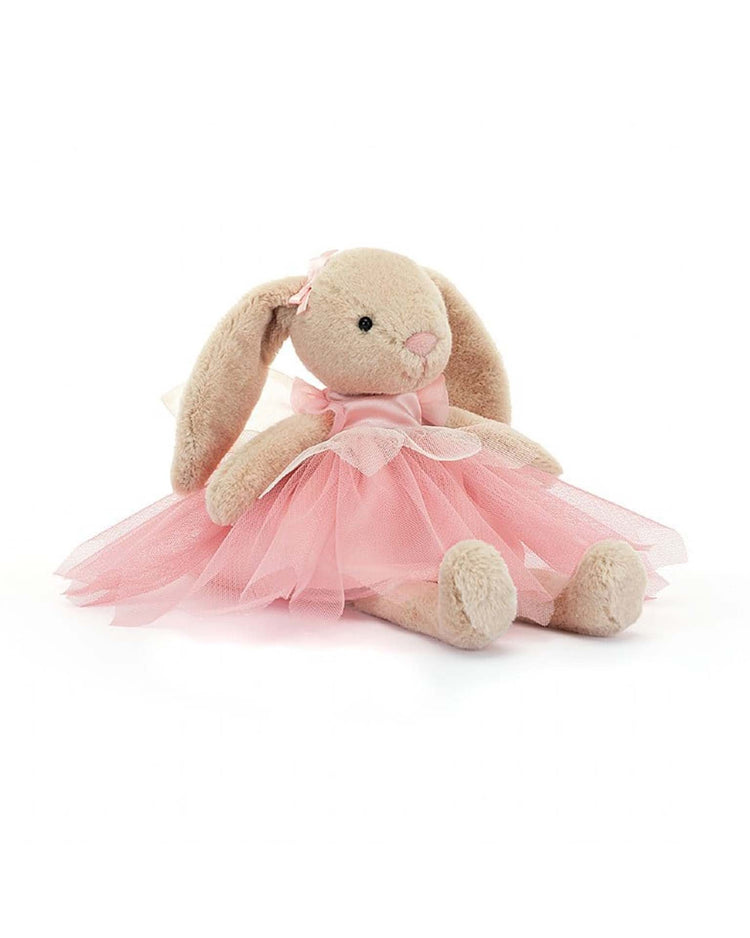 Lottie Bunny Fairy by Jellycat is a charming stuffed animal that sits upright in her pink tulle ballet costume, complete with a bow.