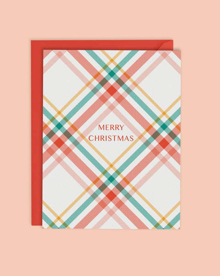The "christmas plaid card" by mellowworks showcases a stylish plaid design with "Merry Christmas" beautifully written in the center, all set against a peach background.