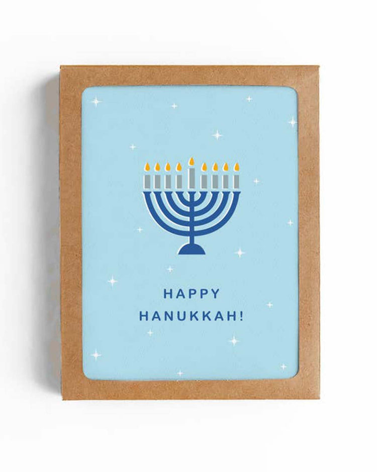 A Happy Hanukkah menorah card from the Mellowworks Happy Hanukkah Menorah Card Set of 6, featuring a stunning illustration of a lit menorah. The text "Happy Hanukkah!" is beautifully printed below the menorah, all enclosed in a tasteful brown frame.