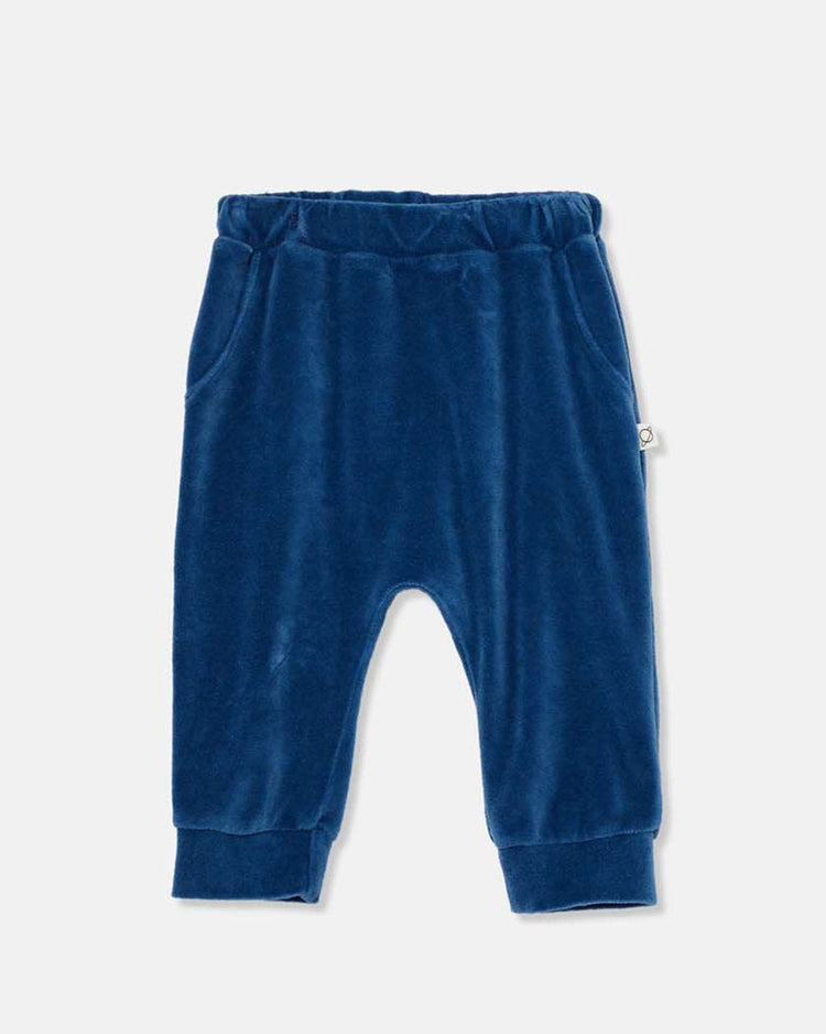 The cozmo chris velour baby pants in blue feature an elastic waistband, side pockets, and cuffed ankles, crafted from soft fabric and shown flat on a plain light background.
