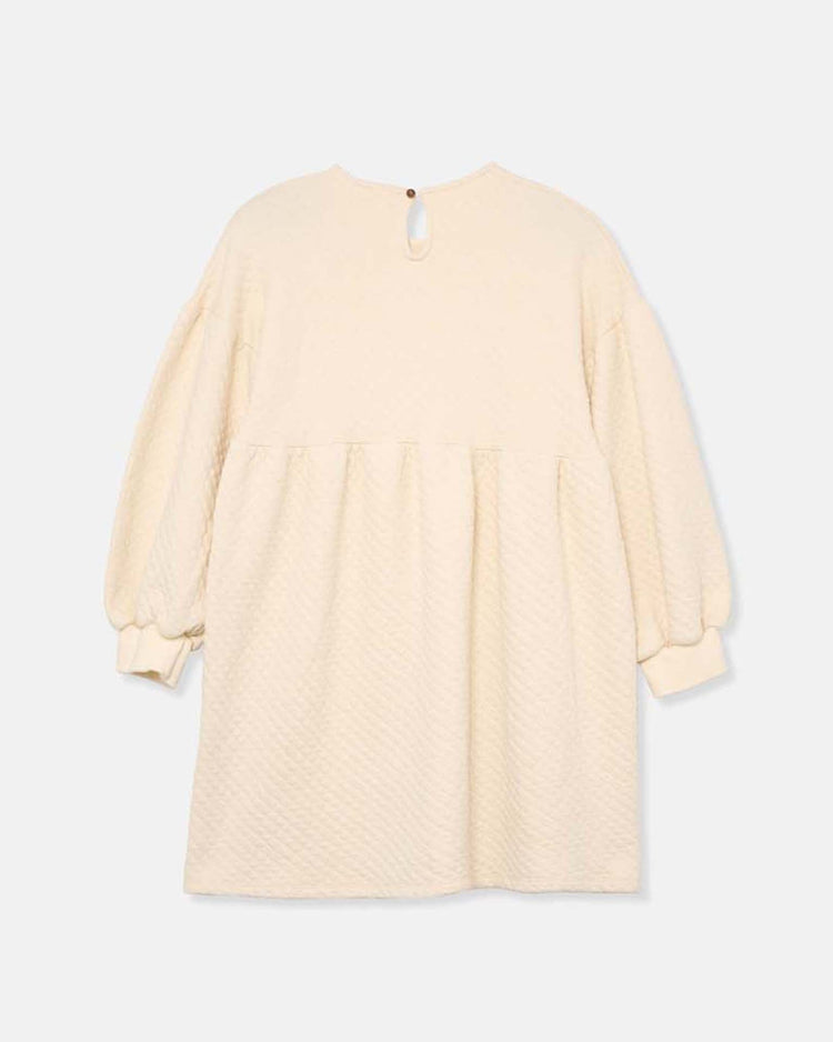 The creta diamond quilted dress in ivory by cozmo features long sleeves, a loose fit, gathered waist, and back button closure—a cozy choice from the Back to Cozmo collection for transitional wear.