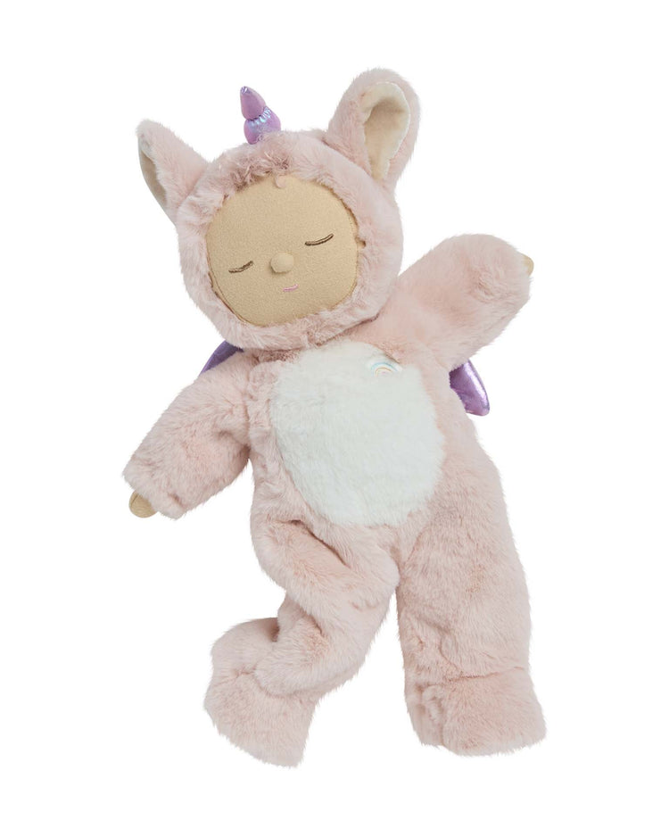 The cozy dinkum unicorn sugarpie pink by dinkum dolls is a soft, huggable stuffed animal with closed eyes, dressed in a fuzzy pink unicorn costume with a white belly, purple horn, and small wings—a magical bedtime toy.