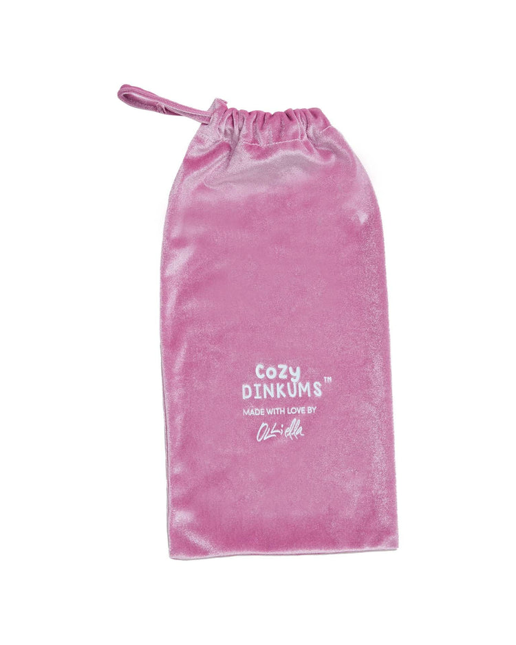 A pink velvet drawstring bag with "Cozy Dinkum Unicorn Sugarpie Pink by Dinkum Dolls" printed in white—perfect for storing your favorite huggable stuffed animal or magical bedtime toy.