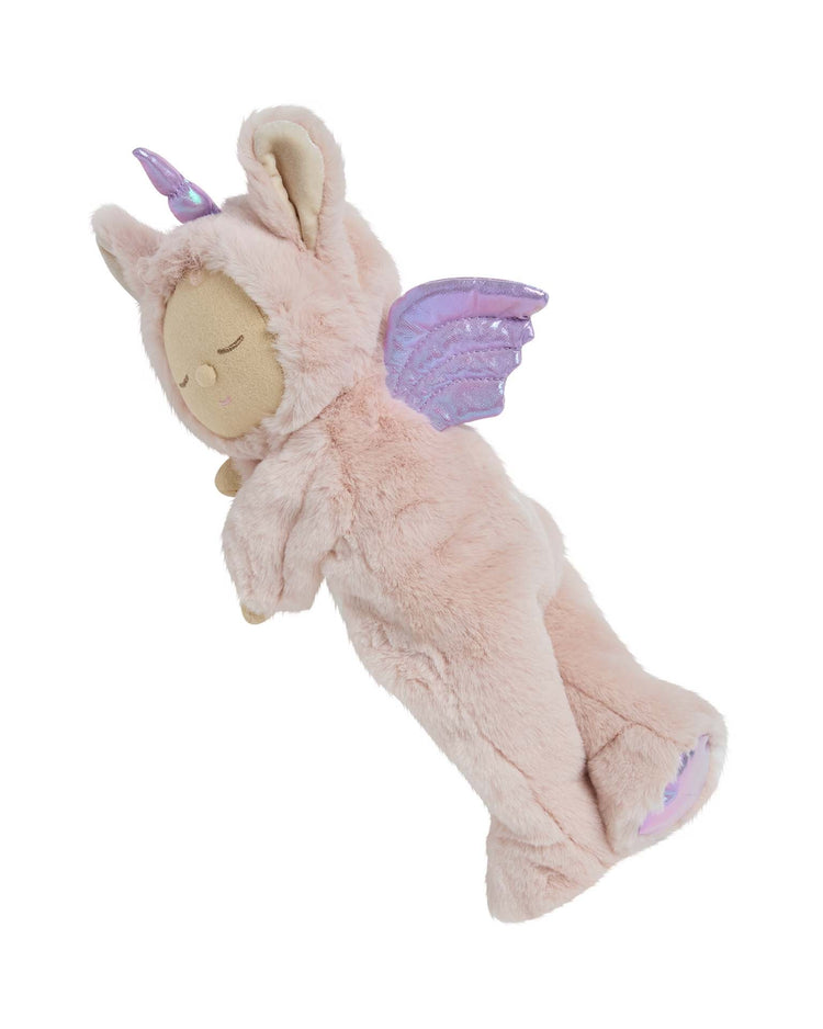 The dinkum dolls cozy dinkum unicorn sugarpie pink is a huggable stuffed animal in a soft pink unicorn costume with a purple horn, lilac wings, and embroidered feet details, lying sweetly on its side against a white background.