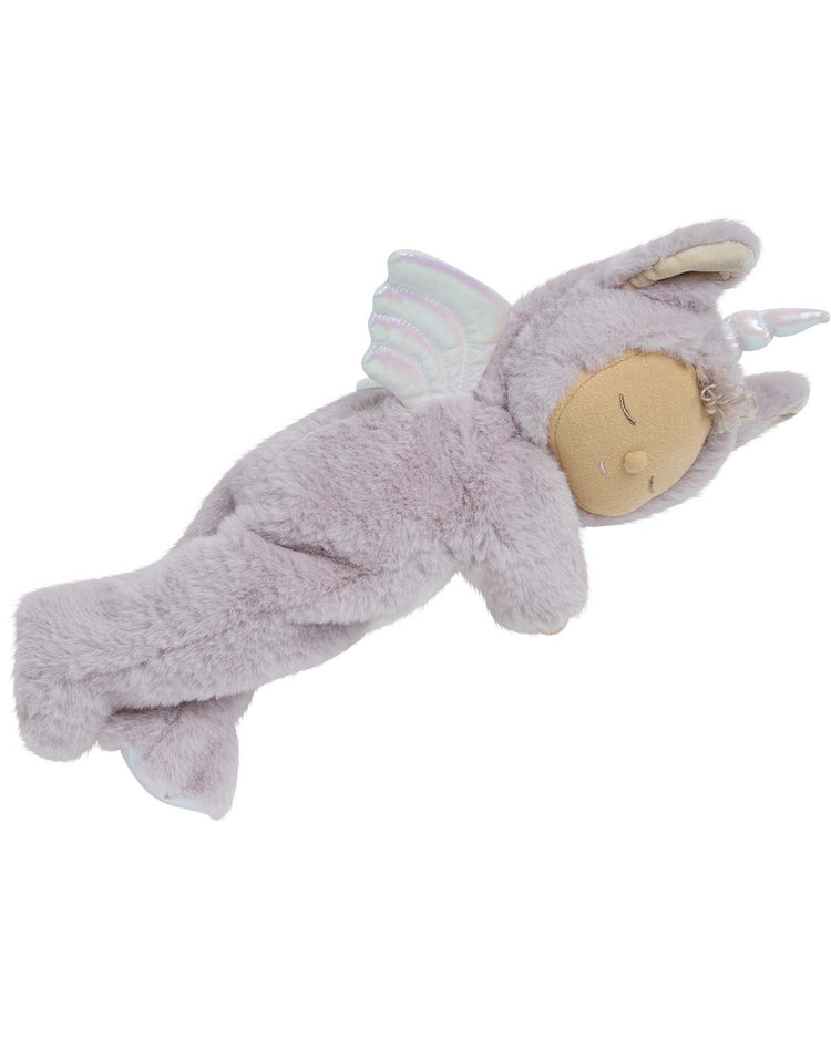 The cozy dinkum unicorn sweetpea lilac by dinkum dolls is a soft, light purple stuffed animal with a horn, ears, and iridescent wings, lying on its side with eyes closed—a dreamy companion for snuggles.