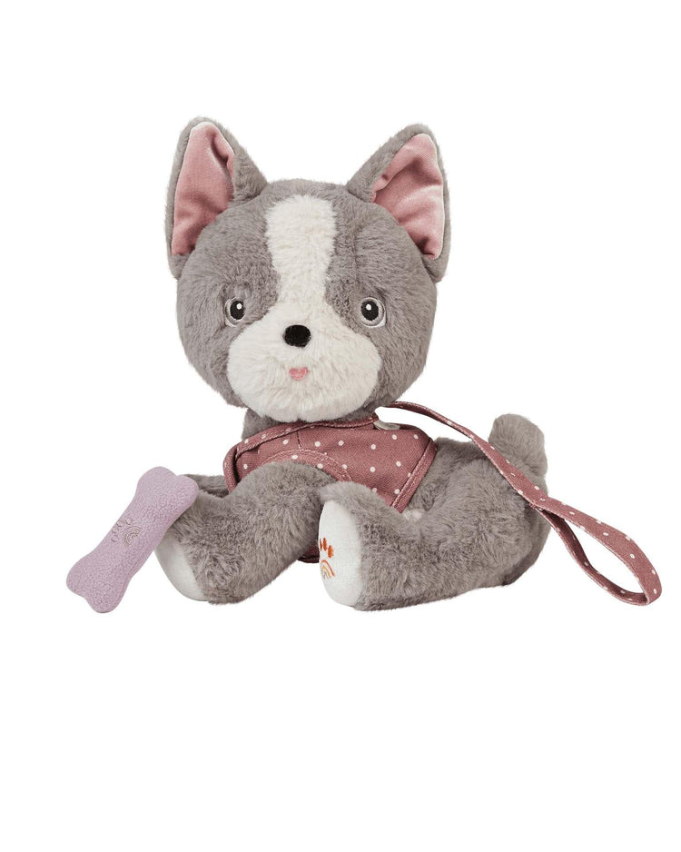The dinkum dolls Dinkum Dog Gizmo is a plush recycled dog toy with pink ears and a pink polka dot harness and leash, holding a small purple magnetic bone accessory.