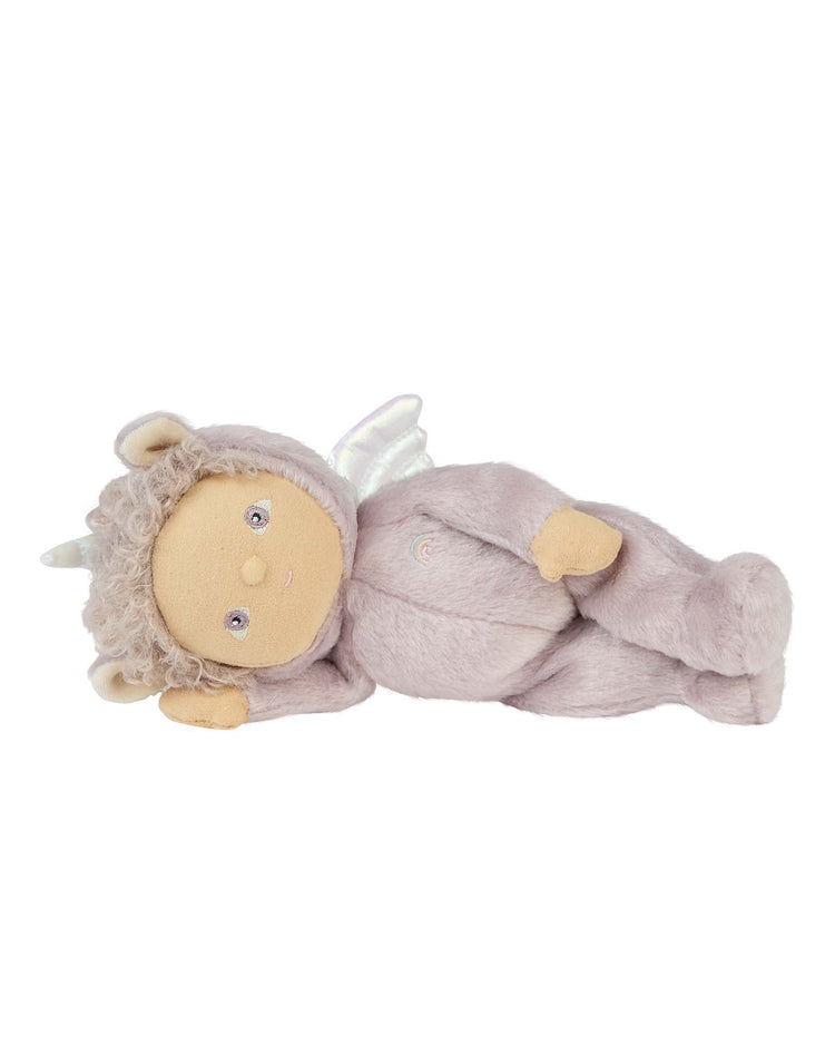 The dinkum dolls dinky dinkum doll uma unicorn lilac features a soft beige face, curly gray hair, button eyes, sparkly white wings, and a fuzzy light purple costume with small horns.