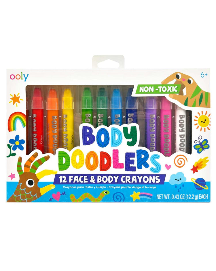 A set of 12 non-toxic face and body crayons by Ooly, labeled "Body Doodlers Face & Body Crayons." These assorted color crayons come in a package with playful illustrations, making them perfect for creating temporary body art. Suitable for ages 6 and up.