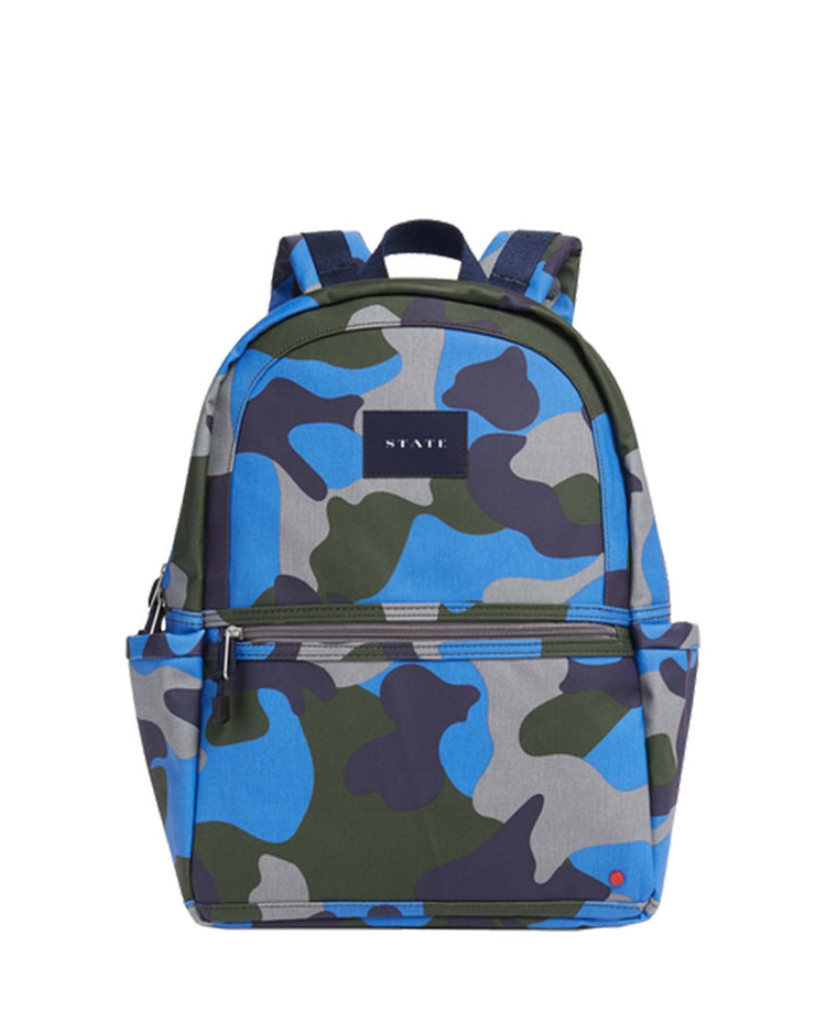 A blue and green camouflage-patterned backpack with black straps and multiple organizational zip pockets. The brand name "state bags" is visible on the front, making it a standout piece for both style and functionality. Perfect as your new kane kids backpack in navy camo.