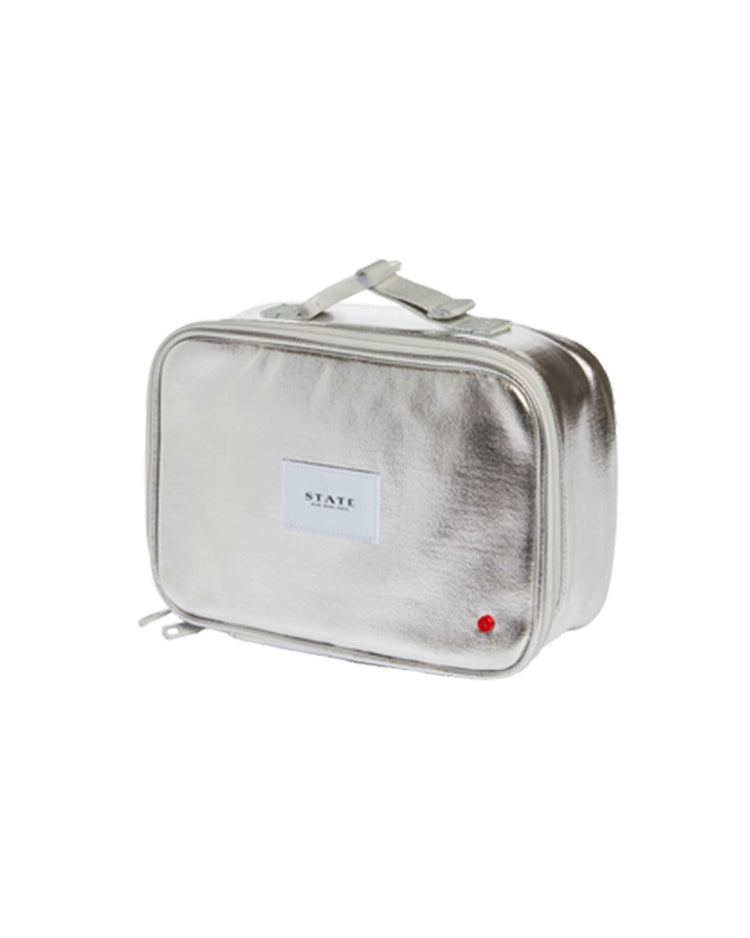 Metallic silver rectangular toiletry bag by STATE BAGS with zip closure, top handle, and front white STATE label. Features an insulated main compartment inspired by the Rodgers Lunch Box in Silver - Old SKU.
