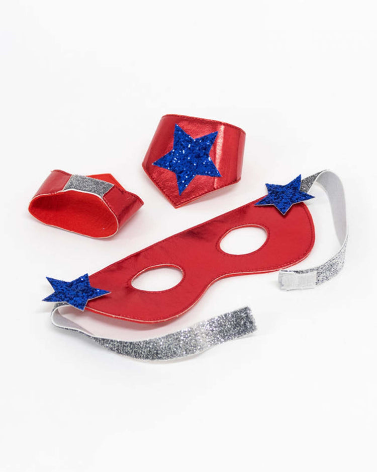 Transform your child's playtime with the meri meri blue superhero costume—a dazzling blue mask with silver straps and shimmering blue glitter stars, complemented by coordinating red wristbands and a bold red badge, each adorned with sparkling blue stars. Beautifully displayed against a white background, this vibrant cape and mask set makes an ideal addition to any Blue Superhero Dress Up Kit.