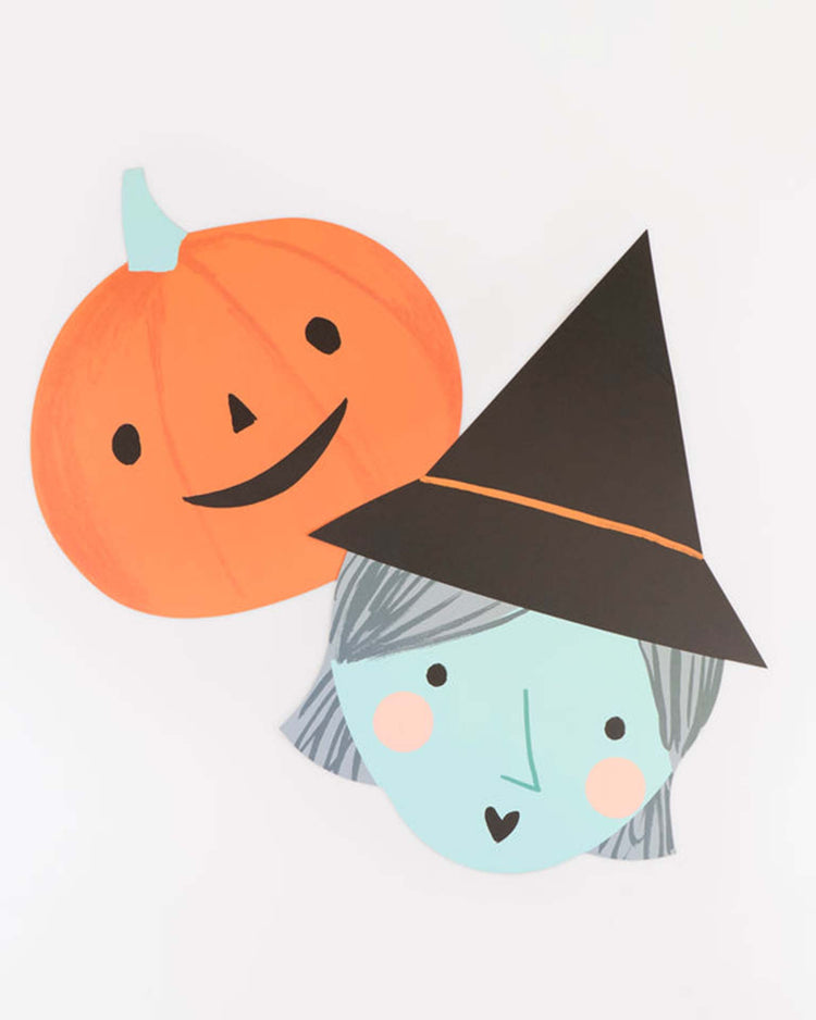 Add a festive touch to your table with meri meri halloween heads placemats—featuring playful paper cutouts of a smiling orange pumpkin and a blue-faced witch with pink cheeks, gray hair, and a black pointed hat. Perfect for whimsical Halloween decor or as unique paper placemats at your next celebration.