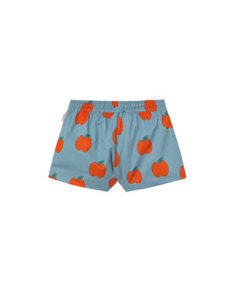 Explore the high-quality "apples trunks in warm grey" by tiny cottons, showcasing a pattern of orange apples and green stems. Their playful design adds whimsical style to your attire.