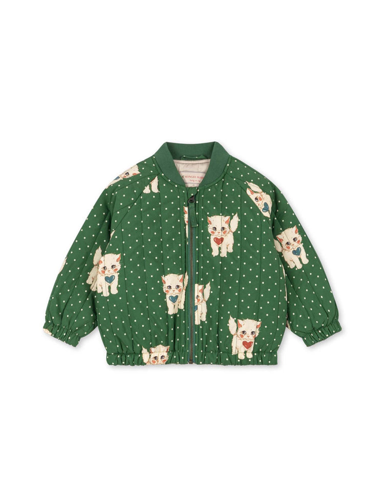 Introducing the juno printed bomber jacket in dot miao verde by konges sløjd—a green, quilted children's jacket adorned with white polka dots and whimsical cat illustrations. This lightweight thermo bomber features a front zipper and elastic cuffs, offering wind-resistant and water-repellent protection for all-weather adventures.
