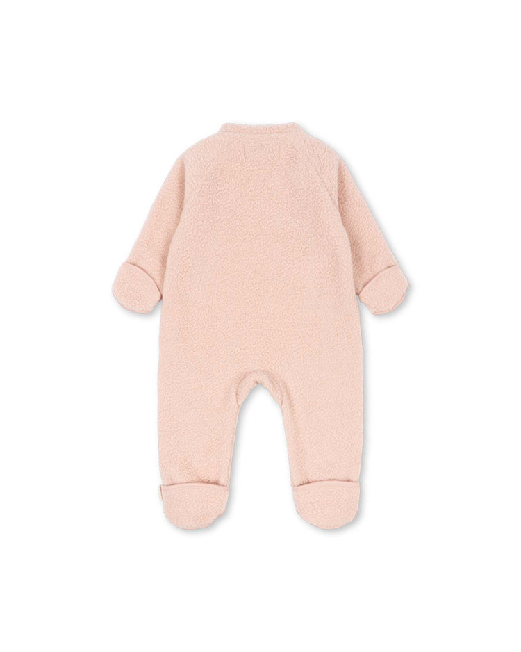 The safa onesie in rose smoke by konges sløjd is a light pink, long-sleeve, footed baby fleece onesie crafted from soft recycled polyester fabric with foldable cuffs, displayed from the back against a white background.