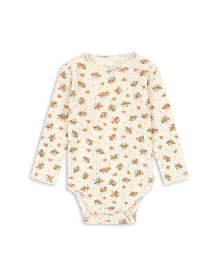 The minnie bodysuit in rosetto by konges sløjd features long sleeves and a cream background with a delicate orange and green floral print, all crafted from soft organic cotton—making it a perfect addition to your baby essentials.