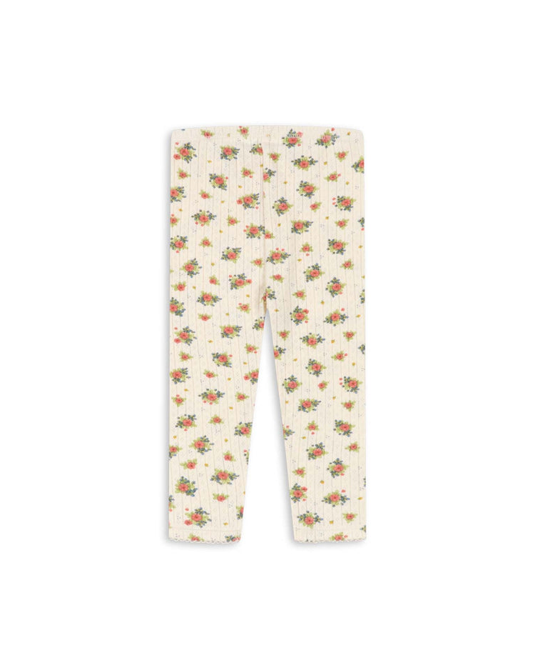 The minnie pants in rosetto by konges sløjd are white ribbed organic cotton leggings adorned with a delicate pink and green floral pattern. The leggings are displayed laid flat against a white background.