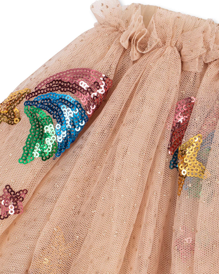 Close-up of the yvonne skirt in rainbow star by konges sløjd, featuring peach-colored tulle adorned with colorful sequin appliqués in the shapes of rainbow stars and rainbows—perfect for a whimsical tulle or sequin skirt look.