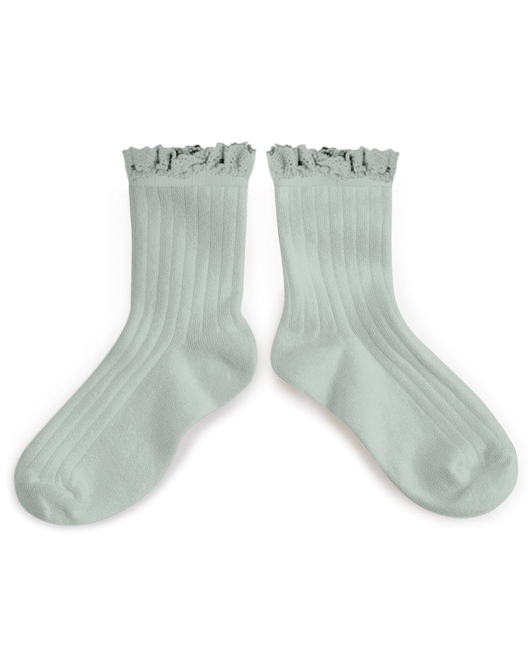 A pair of light green, Collegien Lili Ankle Socks with ruffled beauties on a white background.