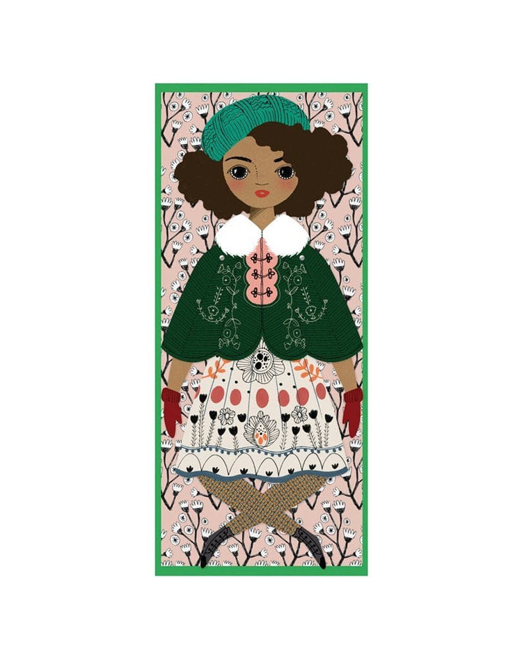 Illustration of a handmade Of Unusual Kind Noelle Mailable Paper Doll with a green hat and a patterned dress against a floral background.