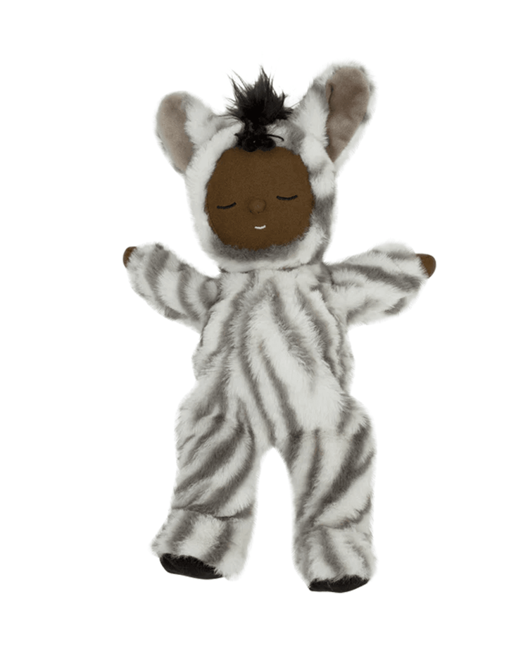 The dinkum dolls cozy dinkum zebra mini is a plush doll with brown skin, closed eyes, and a peaceful expression, wearing a soft striped zebra costume with black-and-white fur, large ears, and a tuft of black hair.