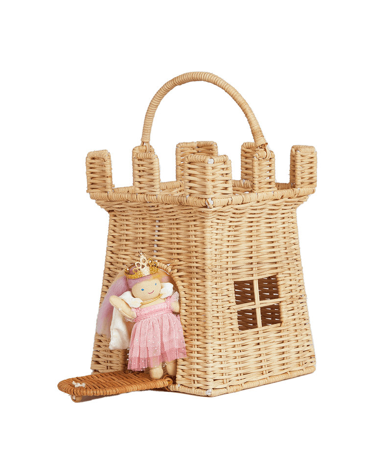 The dinkum dolls rattan castle bag is a handwoven basket with handle and turret details, featuring an attached plush princess doll in a pink dress and crown—ideal for imaginative play.
