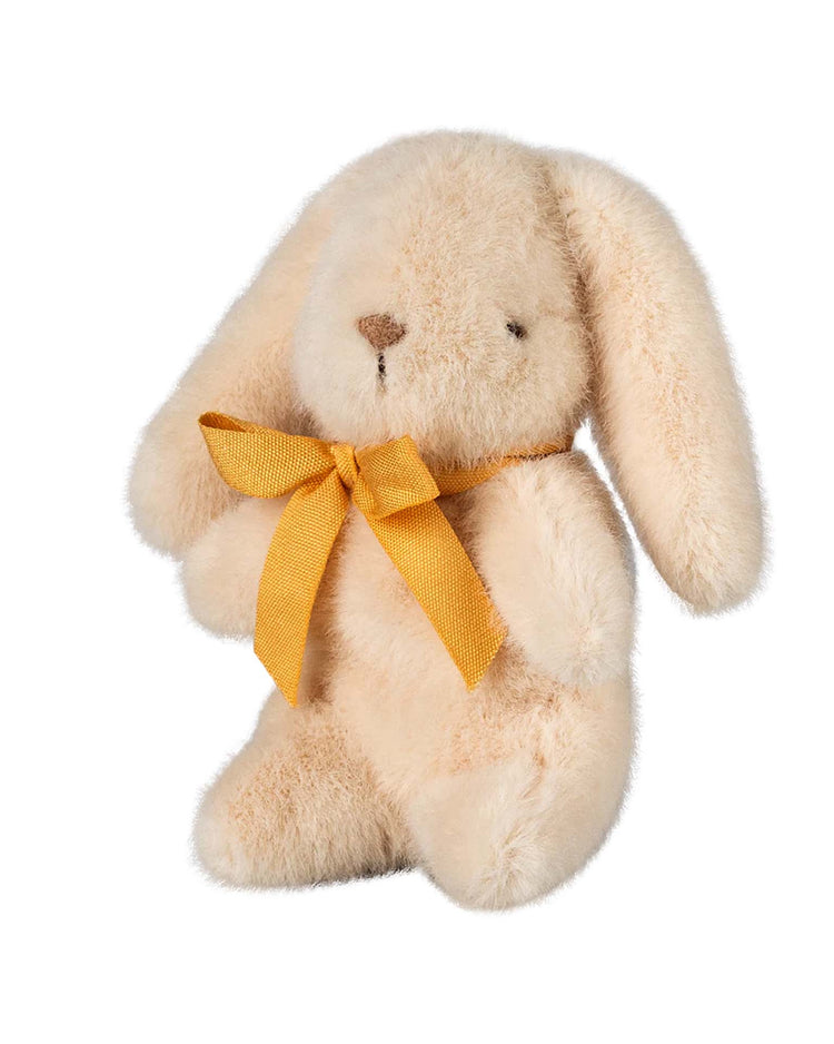 The mini bunny plush in cream by maileg features long ears and a yellow ribbon, crafted from soft plush fabric for a sweet look.