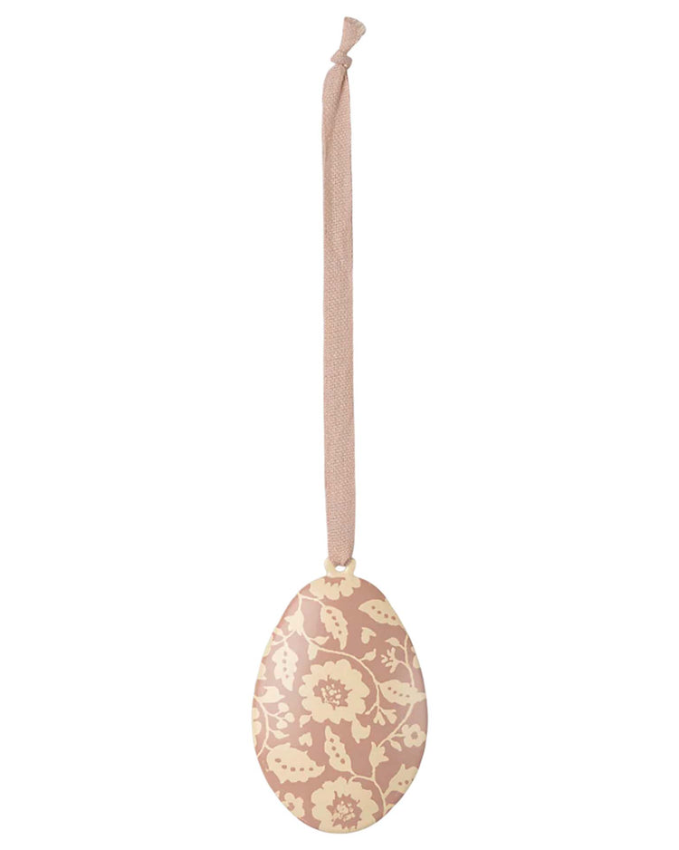 Maileg's "flowers easter egg ornament in dark powder," decorated with beige and white floral prints, hangs elegantly from a beige ribbon.