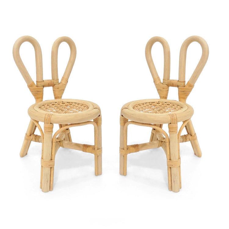 The Poppie Mini Bunny Chair Set by poppie toys features two small rattan chairs with rounded, looped backrests and woven seats in a natural light wood—perfect kids’ furniture for a whimsical tea party, shown side by side on a white background.