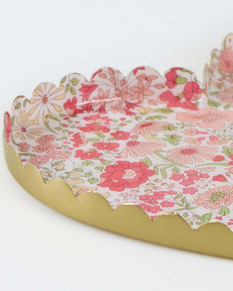 The meri meri x liberty heart large accessory tray by meri meri features scalloped gold edges and a vibrant Liberty floral print in pink, red, and green—an ideal and lively Valentine’s gift.