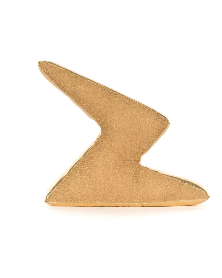 A gold, abstract geometric sculpture shaped like a stylized zigzag evokes the playful Jellycat Amuseables Zapperty Lightning Bolt plush toy, set against a plain white background.