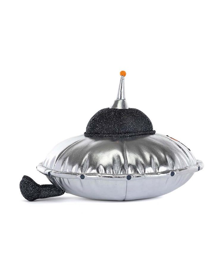 Meet the Jellycat Amuseables Jellysaucer: a cosmic disco plush featuring a silver saucer shape, black glittery top, orange antenna, and playful black tail—universally friendly and irresistible!.
