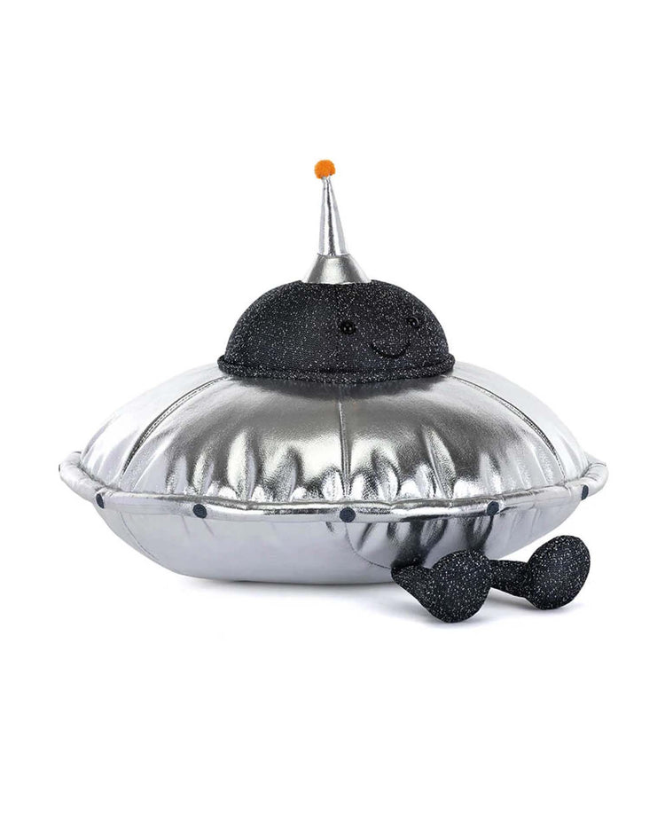 Meet amuseables jellysaucer by Jellycat—a smiling silver UFO plush with a glittery black dome, orange antenna, and two black legs with round feet. Your Universally Friendly Object!.