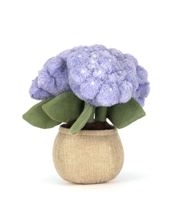 Jellycat's Amuseables Hydrangea is a plush toy shaped like a potted hydrangea, with soft purple flowers, green leaves, and a textured brown pot—perfect for adding cottage garden charm to any room. Shown on a white background.