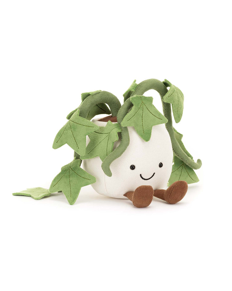 The Jellycat Amuseables Ivy is a plush toy featuring green leafy vines in a white square pot with a smiling face and brown feet—a cute gift—shown on a white background.