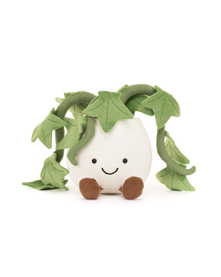 Jellycat’s Amuseables Ivy is a plush toy shaped like a white round pot with a smiling face, brown feet, and soft green leaves—an adorable houseplant-inspired gift for any occasion.