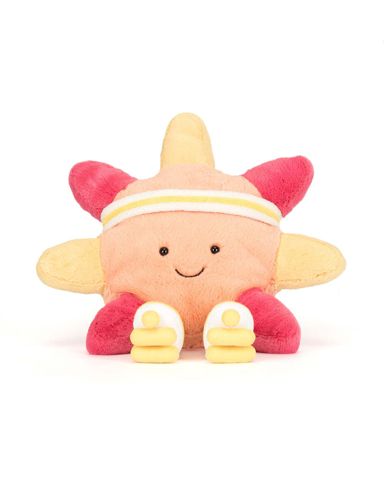 The Jellycat Amuseables Sun Roller Skates is a plush toy shaped like a smiling sun with red and yellow rays, wearing a white and yellow headband, and sporting cute roller skates—a cheerful companion for fun times.